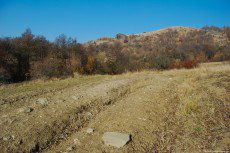 An earth road used by the villagers for climb their carts to the forest, in sunny day of autumn