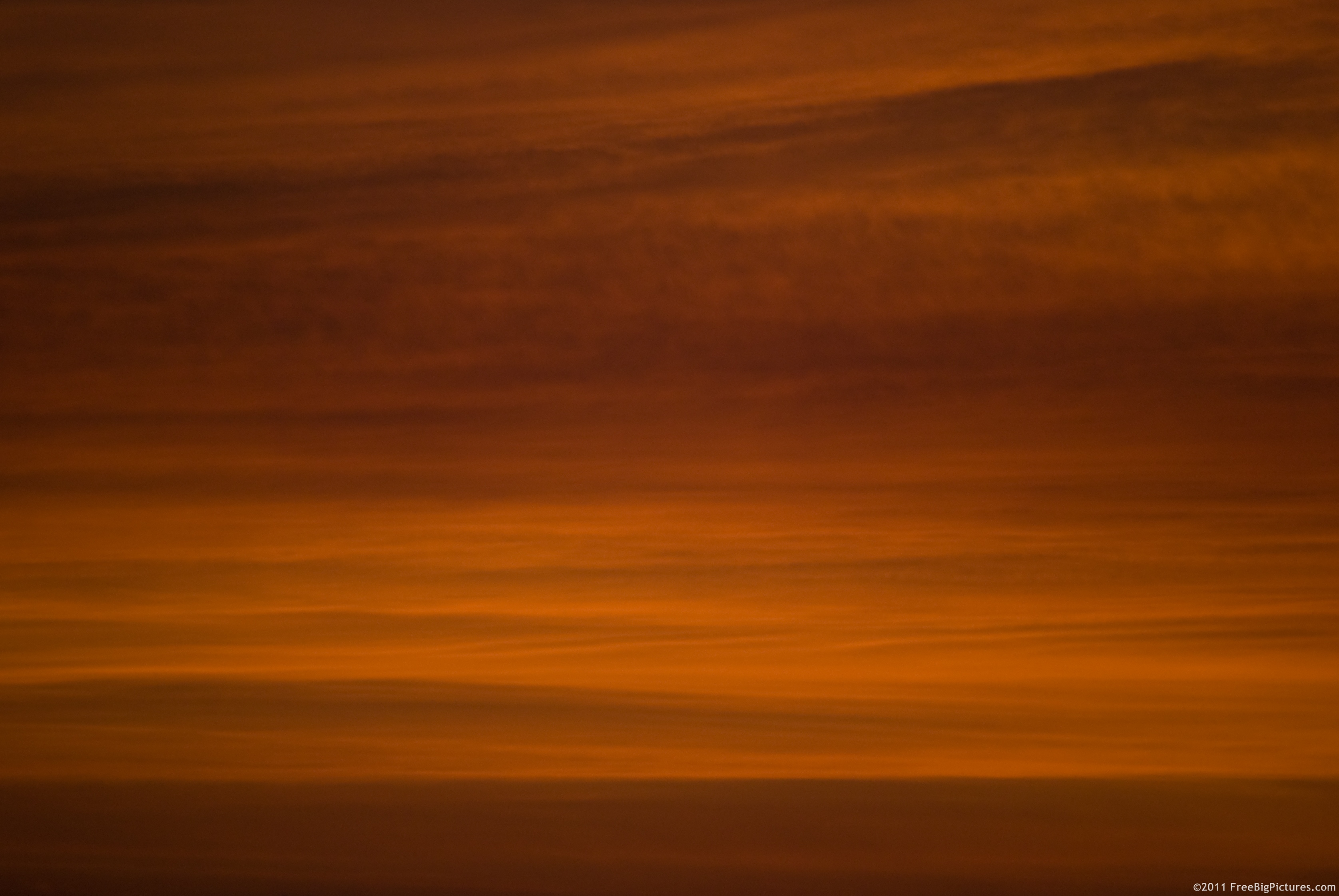 Sunset with red layers of clouds, in a dusty and smoky athmosphere