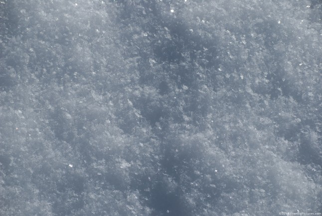 A background with light and shaded portions on snow